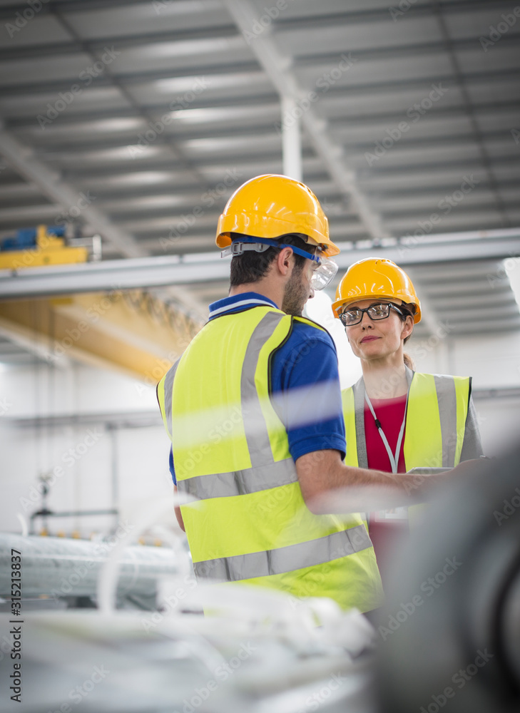 Workers talking in factory Workers talking in factory