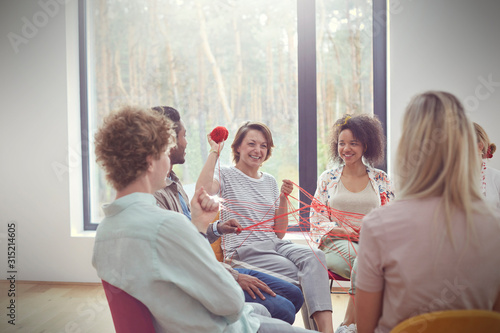 Group therapy session doing team building exercise with yarn photo