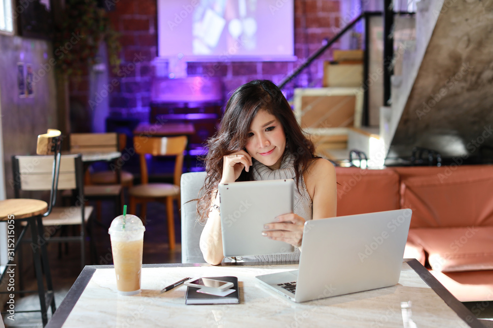 Business selling online, young asian woman in casual dress working on tablet and computer while thinking something for e-business commerce, businesswoman owner SME small business contact with customer Business selling online, young asian woman in casual dress working on tablet and computer while thinking something for e-business commerce, businesswoman owner SME small business contact with customer