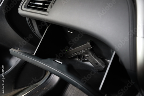 concealed gun in storage rack car. crime concept