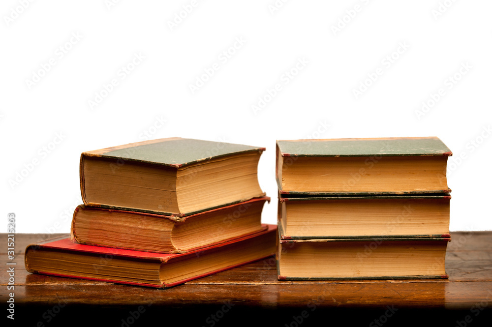 stack of old books on wooden table with white background stack of old books on wooden table with white background