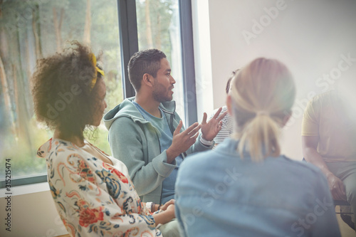 Man talking and gesturing in group therapy session