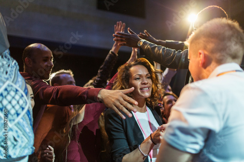 Audience reaching for and talking with speakers