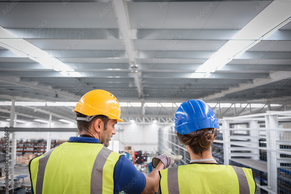 Supervisors working on platform in factory Supervisors working on platform in factory