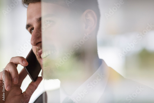 Close up smiling businessman talking on cell phone