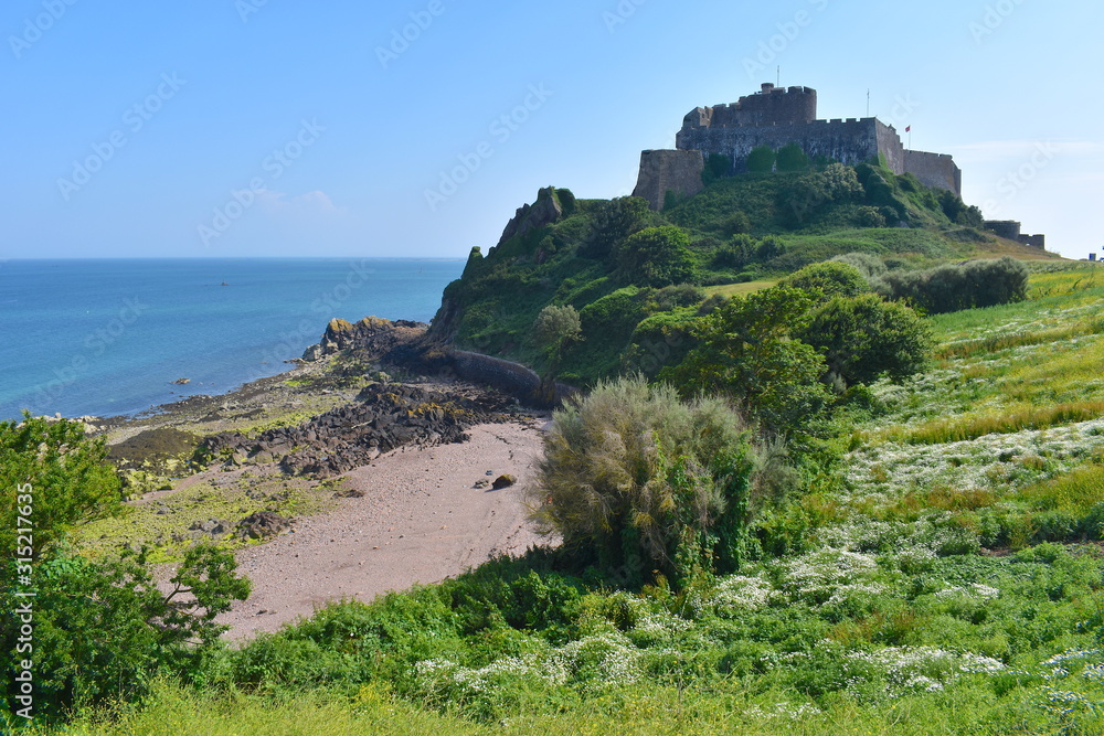 View of Mont Orgueil castle and the east coast of Jersey The fortress protected the isle against French invasion Explore network of staircases and secret rooms to discover hidden treasures and artwork