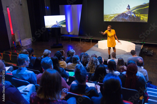 Female speaker on stage answering audience questions