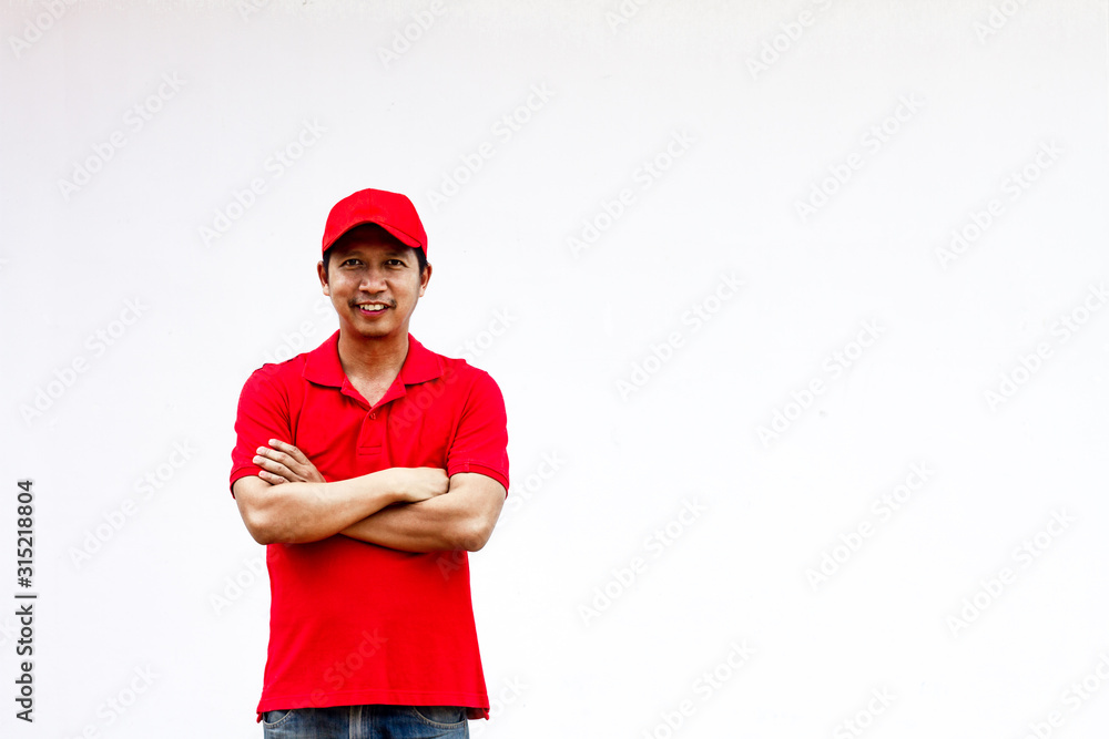 Men wearing red shirts and hats stand happily with their arms crossed. Men wearing red shirts and hats stand happily with their arms crossed.