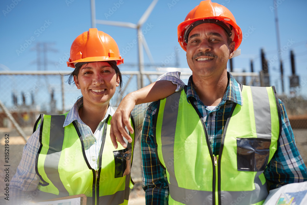 Portrait confident, smiling engineers at power plant Portrait confident, smiling engineers at power plant