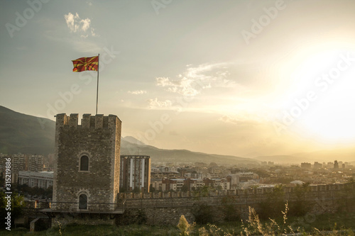 Outlook tower of the Skopje Fortress, also called Skopsko Kale, in the capital city of Northern Macedonia, with a panorama of the landscape of the city and a Macedonian flag waiving