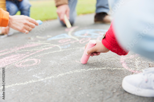 Girl drawing with sidewalk chalk