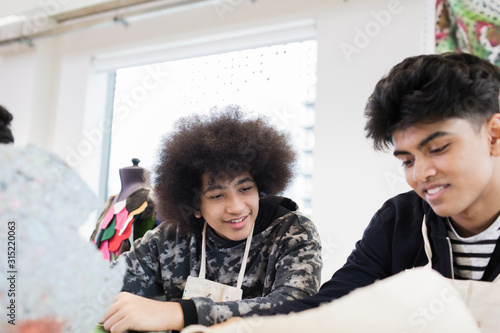 Teenage boys in high school art class