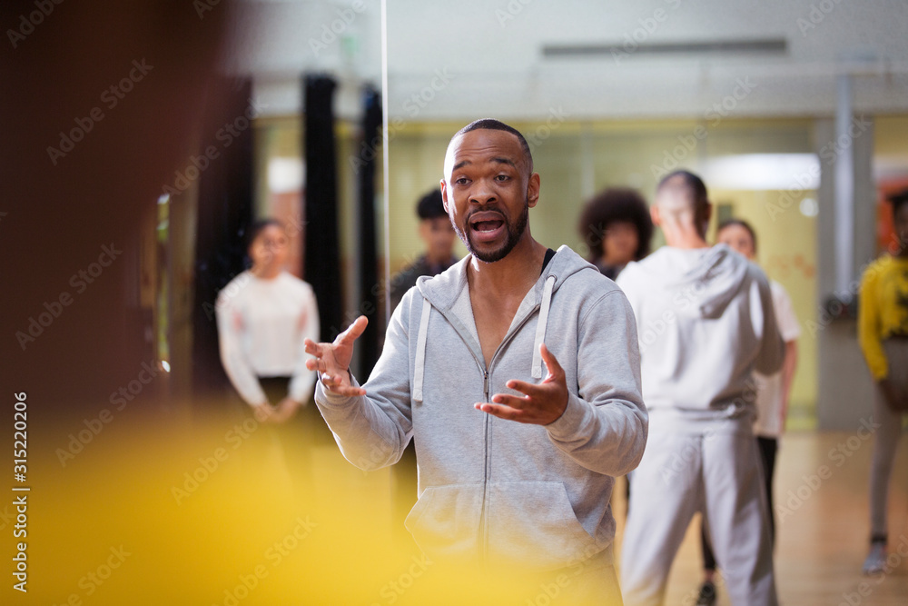 Dedicated male instructor teaching dance class in studio Dedicated male instructor teaching dance class in studio