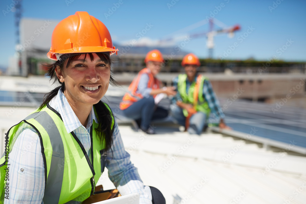 Portrait smiling, confident female engineer at sunny power plant Portrait smiling, confident female engineer at sunny power plant