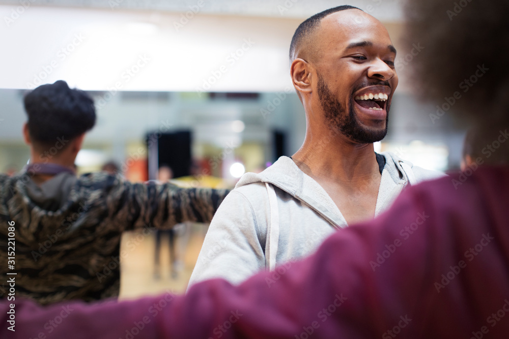 Laughing dance instructor enjoying dance class in studio Laughing dance instructor enjoying dance class in studio