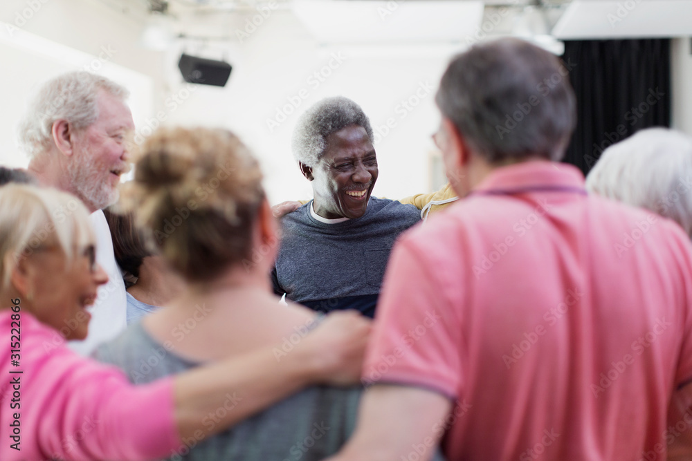 Active seniors forming circle huddle Active seniors forming circle huddle