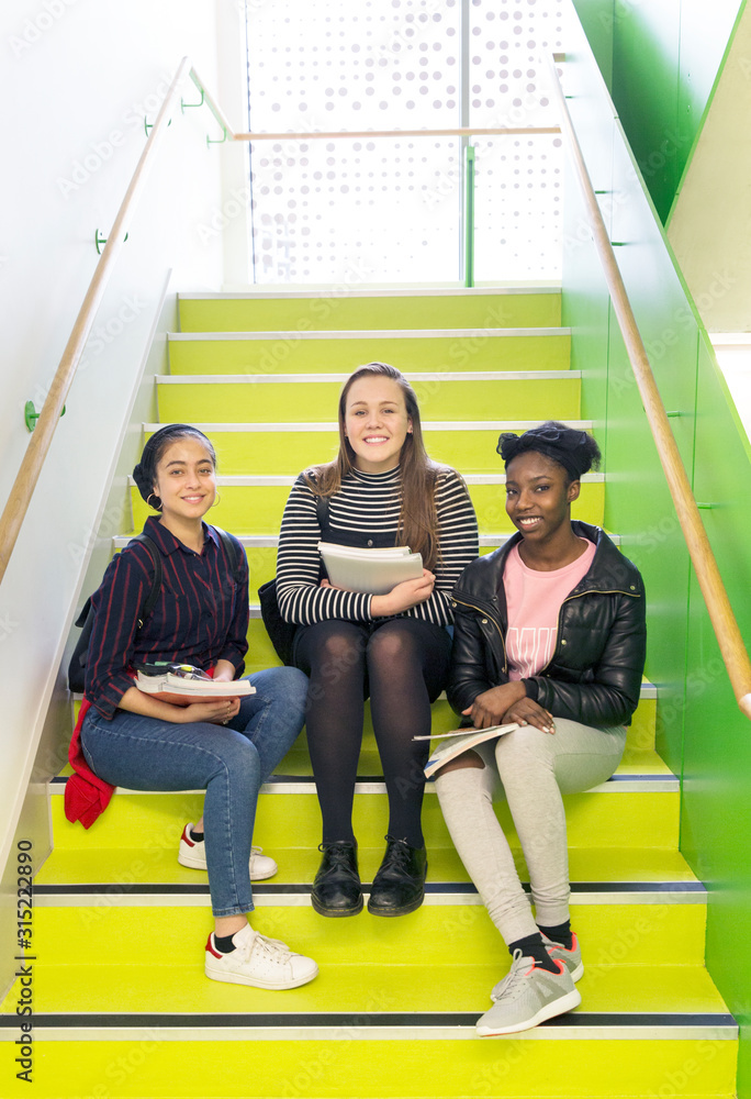 © Rob Daly/Caia Image - Portrait smiling, confident high school girls sitting on stairs