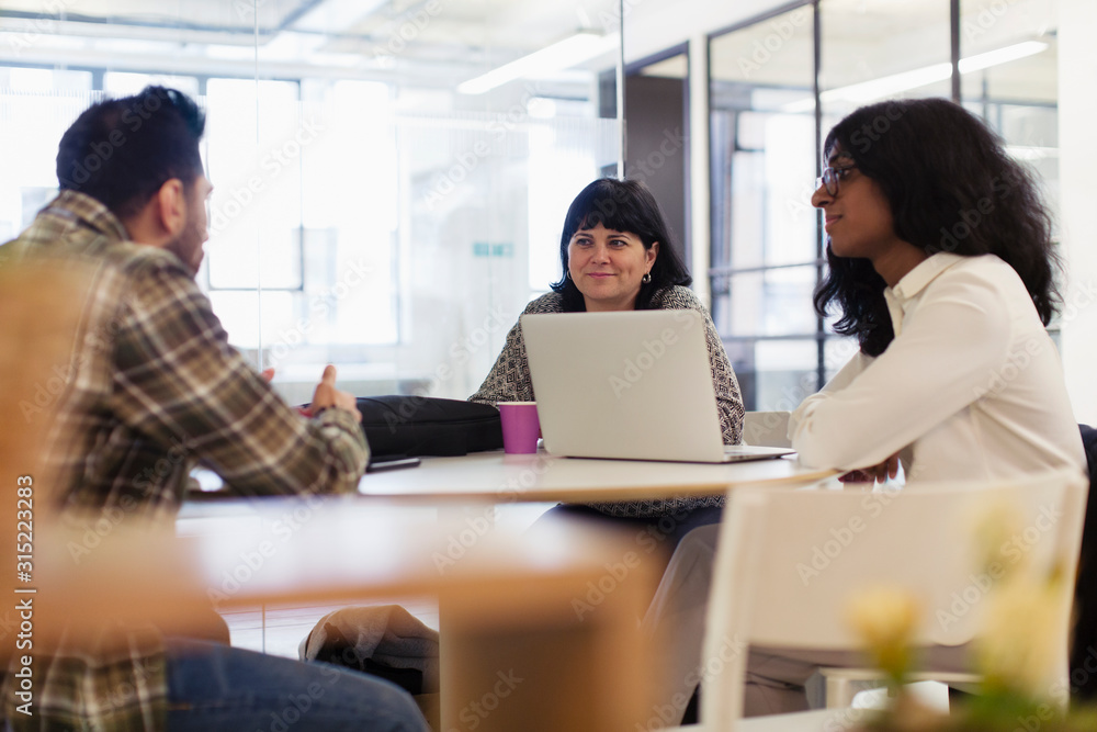 Business people with laptop talking in office meeting Business people with laptop talking in office meeting