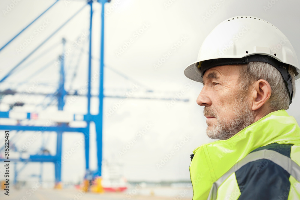Dock worker looking away at shipyard Dock worker looking away at shipyard