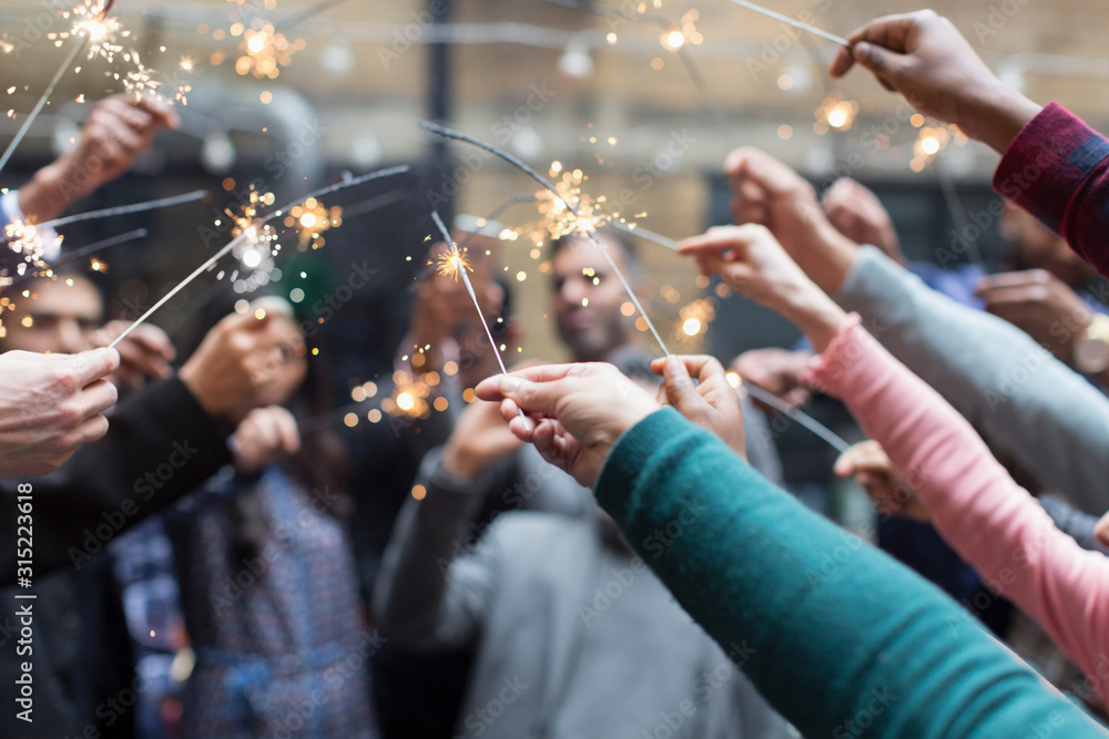 © Martin Barraud/Caia Image - Friends celebrating with sparklers