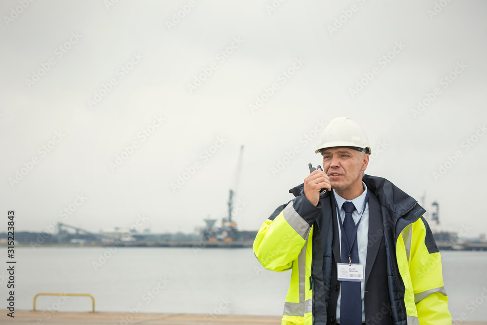 Dock manager using walkie-talkie at commercial dock