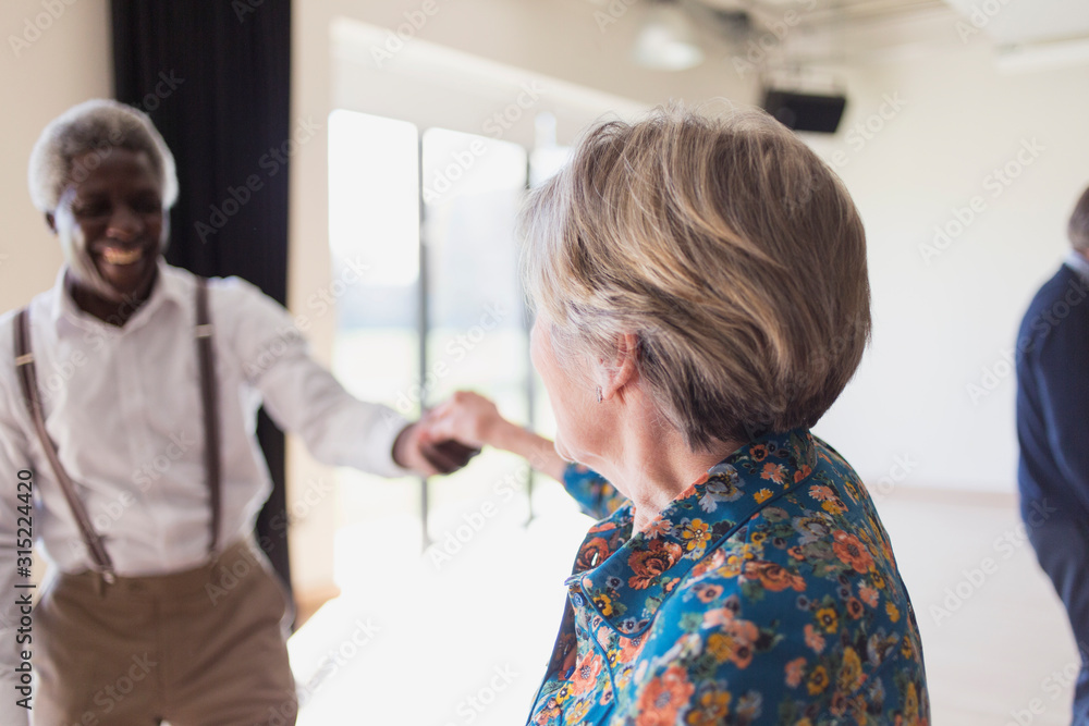 Active senior couple dancing in dance class Active senior couple dancing in dance class