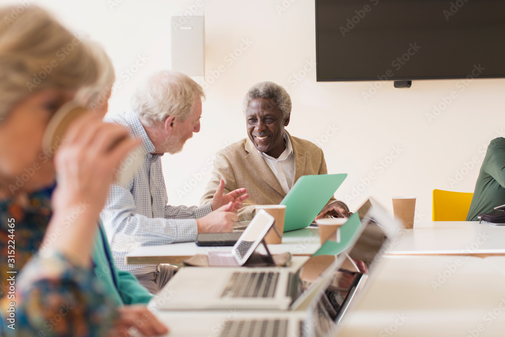 Senior businessmen using laptop in conference room meeting Senior businessmen using laptop in conference room meeting