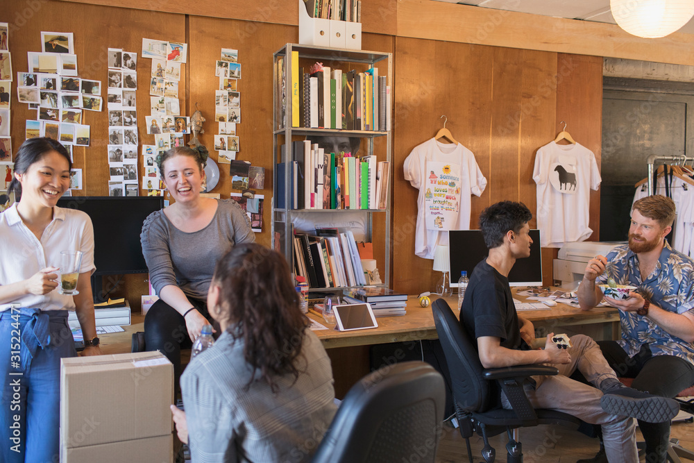 Laughing creative designers working in office Laughing creative designers working in office