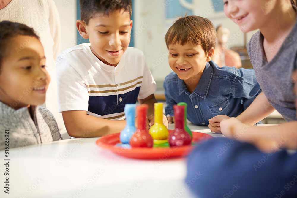 Curious kids watching foam in beakers Curious kids watching foam in beakers