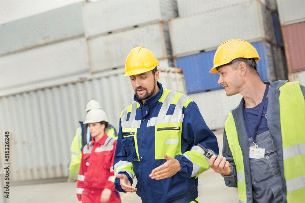 Dock workers walking and talking at shipyard Dock workers walking and talking at shipyard