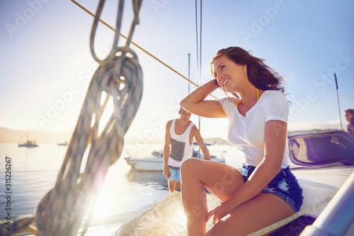Happy young woman relaxing on sunny boat photo