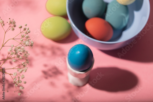 Easter eggs  flower and plate on pink background