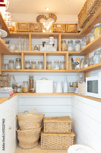 Woven baskets and food jars in pantry photo
