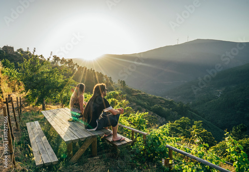 Couple enjoying sunny, idyllic hillside view, Chas de Egua, Portugal photo