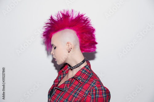 Portrait confident young woman with pink mohawk photo