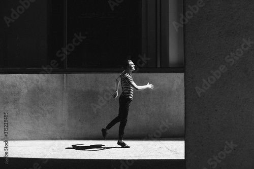 Young men stepping on urban pavement