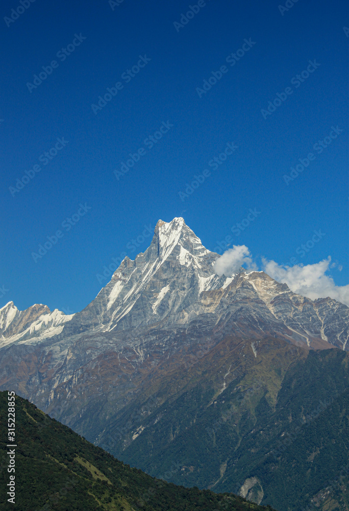 Top of the hill, covered with snow and white clouds