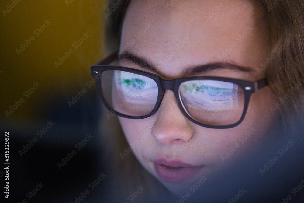 Focused girl in eyeglasses