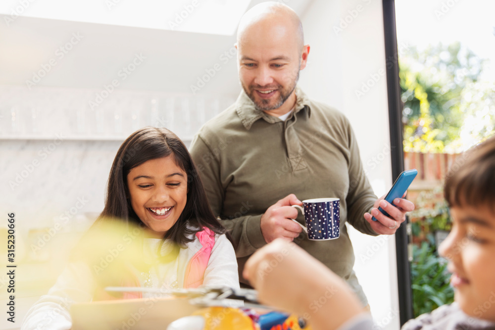 Father and daughter using digital tablet and smart phone Father and daughter using digital tablet and smart phone