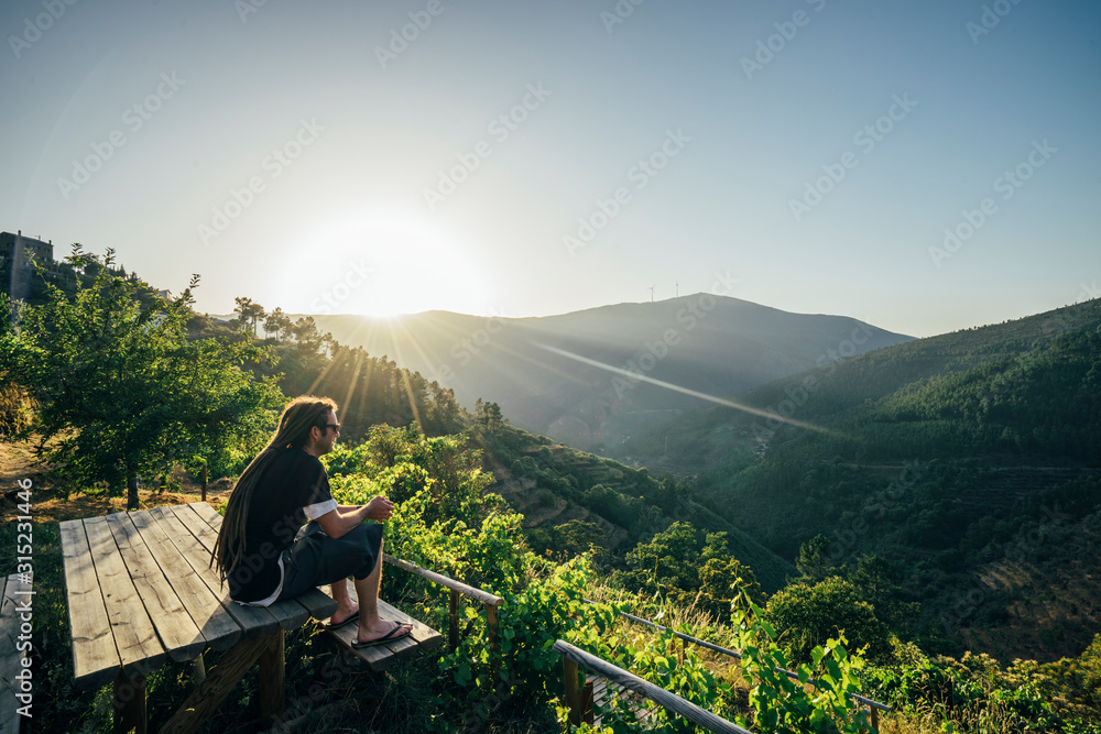 Man enjoying sunny, idyllic landscape view, Chas de Egua, Portugal Man enjoying sunny, idyllic landscape view, Chas de Egua, Portugal