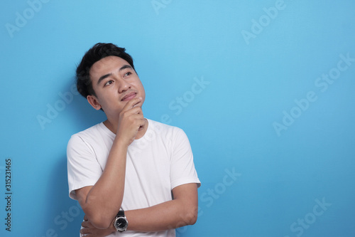 Asian man thinking something, looking for good idea