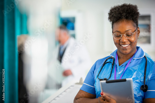 Female nurse using digital tablet in hospital photo