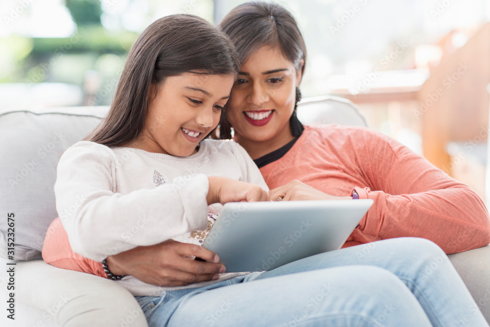Happy mother and daughter using digital tablet Happy mother and daughter using digital tablet