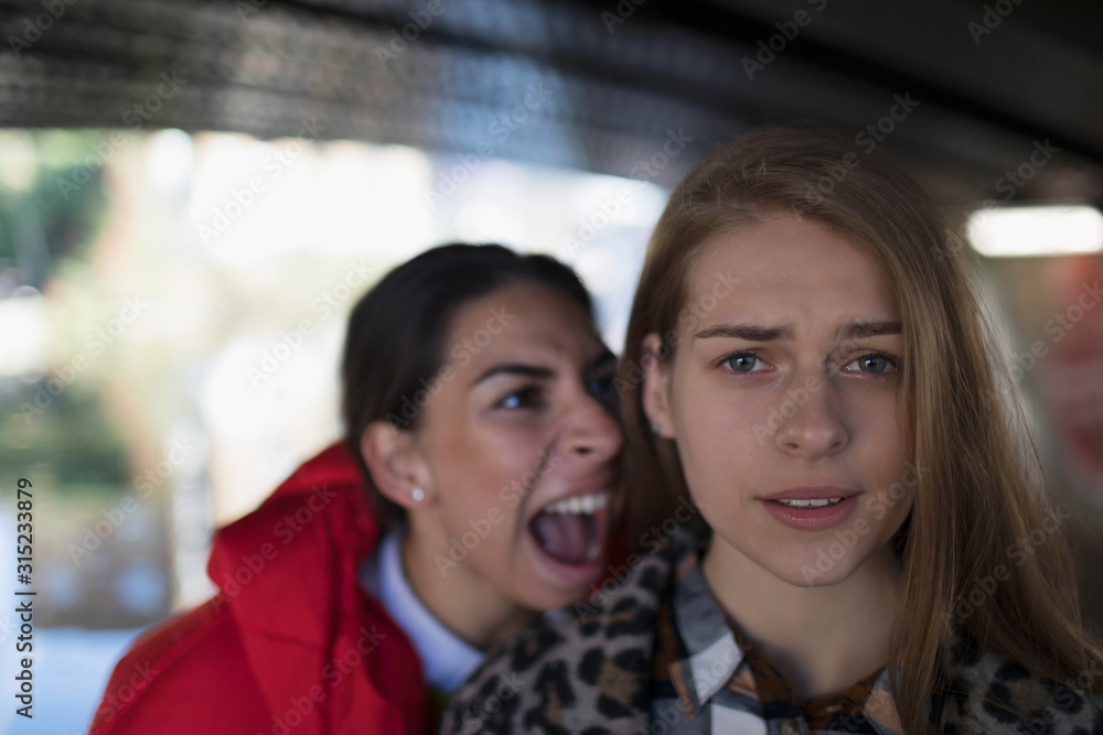 Angry young woman yelling at friend Angry young woman yelling at friend