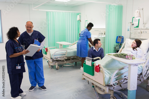 Doctors, nurse and patient in hospital ward
