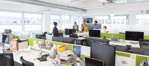 Business people meeting in open plan office photo