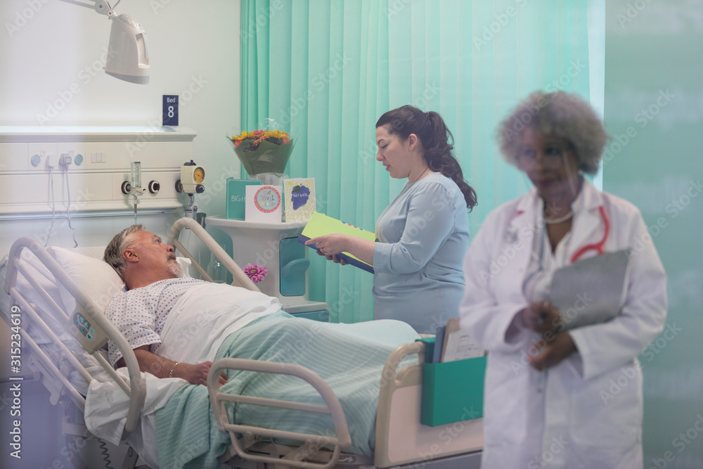 Doctors making rounds, talking with patient in hospital room Doctors making rounds, talking with patient in hospital room