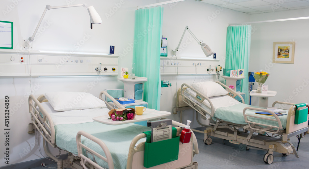 Flowers on trays over hospital beds in vacant hospital ward Flowers on trays over hospital beds in vacant hospital ward