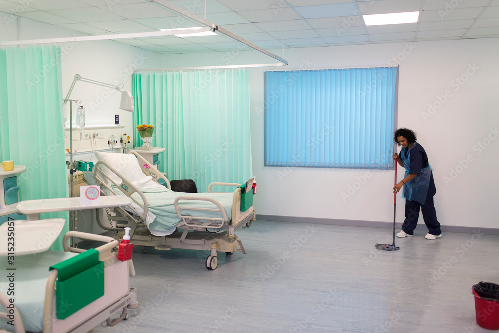 Female orderly mopping hospital ward floor Female orderly mopping hospital ward floor