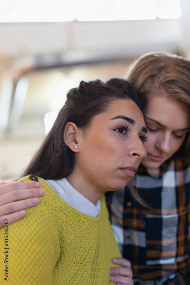 © Tom Merton/Caia Image - Young woman consoling crying friend